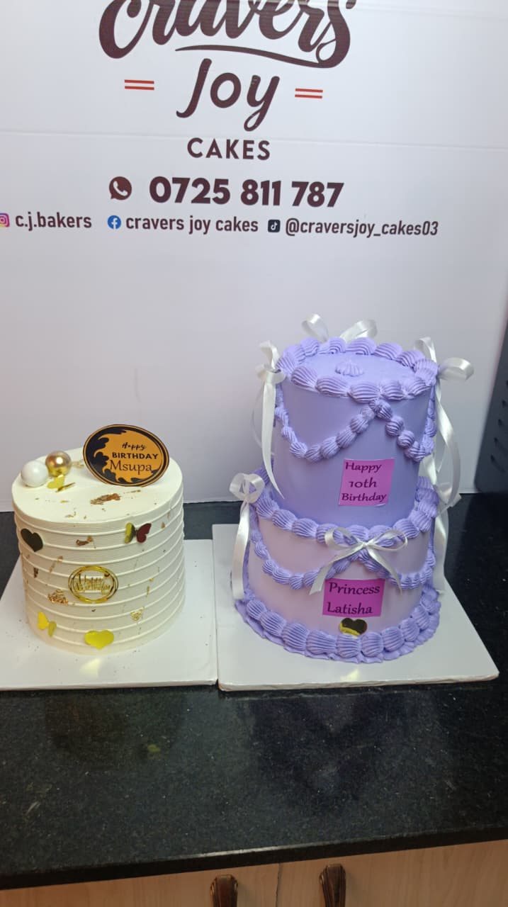 Two finished cakes set up side by side against a party backdrop.
